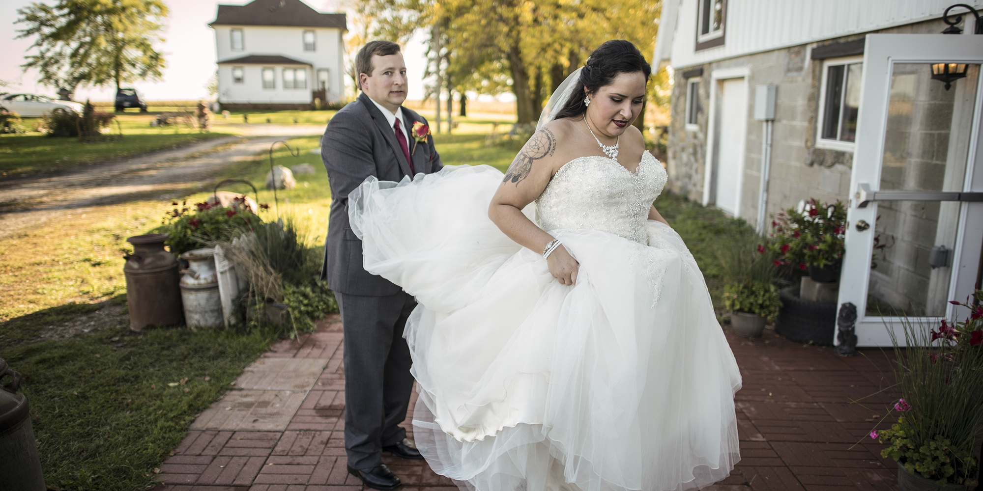groom holding wedding dress